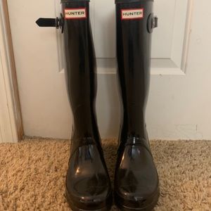 Tall glossy black hunter rain boots